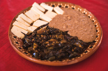 Capon chiles, typical food from the state of Michoacan, Mexico, accompanied by ranch cheese and beans.