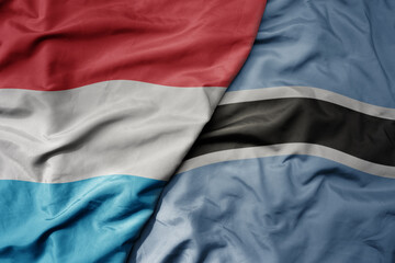 big waving national colorful flag of botswana and national flag of luxembourg .