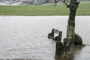 bench surrounded by water at high tide in the River Hamble Country Park Hampshire England