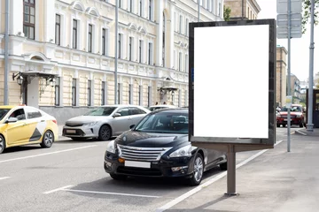 Deurstickers Billboard on a narrow city street with parked cars. Mock-up. © JoyNik