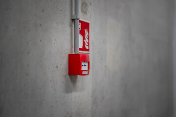 Fire alarm red button. Concrete wall. Emergency alarm.