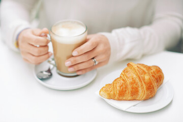 Close up image of freshly baked croissant and cafe latte - 745993682