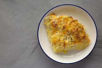 Homemade Hasselback Potato Gratin on a Plate, top view. Copy space.