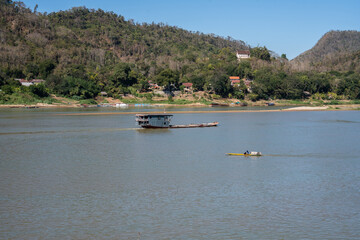 Laotian wooden boats on the Mekong River in Luang Prabang in Laos Southeast Asia