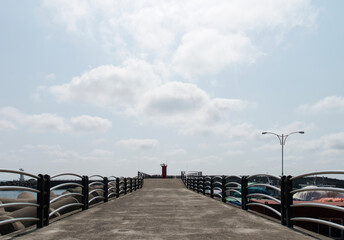 Naklejka premium View of the lighthouse on the seawall