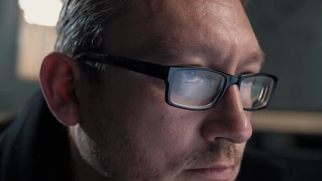 Portrait of man wearing glasses in monitor screen