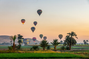 Take off of coloful hot air balloons at sunrise near the the Valley of Kings in Luxor West bank,...