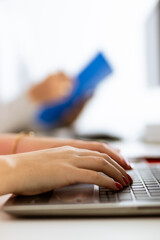 Woman's hands on pc keyboard. Office context.