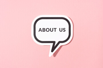 About Us text on speech bubble isolated on pink background