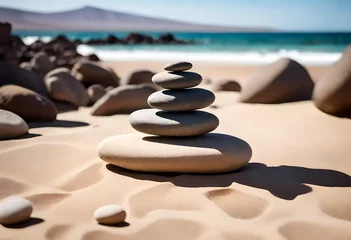 Tuinposter stack of stones on the beach © aimenyounas