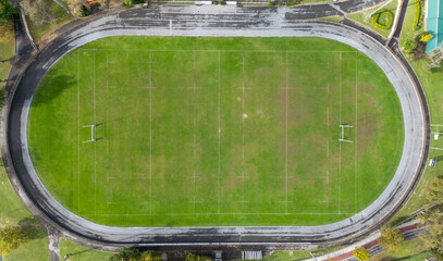 Aerial view of empty rugby field encircled by running track