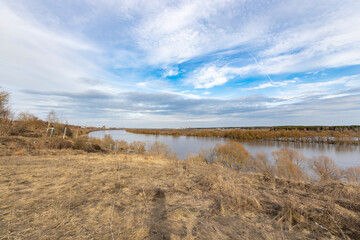 early spring flood, high water in the countryside, river overflowing its banks, trees in the water,...