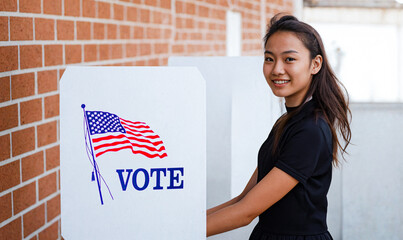 A young Asian American woman is seen casting her vote at a voting booth during the USA general elections. The image captures the diversity, inclusion, and empowerment of women voters and asian