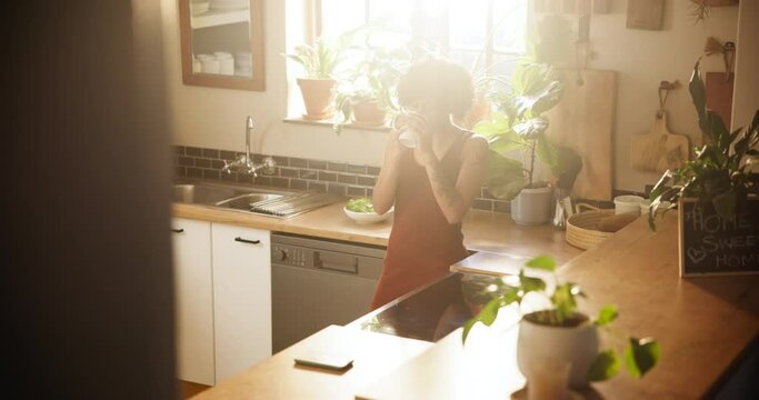Woman, kitchen and drinking coffee in morning or relax for breakfast or thinking at home. Female person with mug or tea cup and enjoying beverage, latte or cappuccino by window for sunshine at house