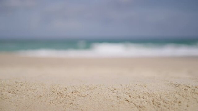 Beach sand close up blurred sky. Sea summer shoreline sands desert macro view. Copy space.