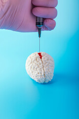 Concept experiments on human brain syringe with red drop of blood