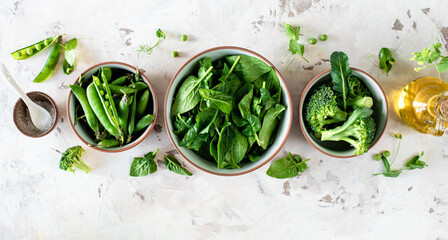 Fresh spinach leaves, green peas, broccoli in a bowl, top view - Powered by Adobe
