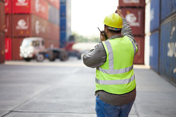 back view worker or engineer using walkie talkie and showing gesture to crane car in containers warehouse storage - obrazy, fototapety, plakaty