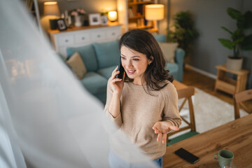 One adult woman stand at home use mobile phone talk