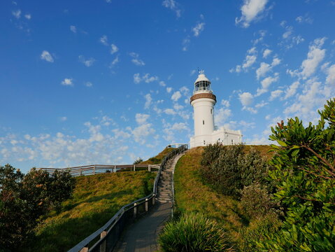 Landscape picture of Cape Byron Lighthouse coastal boardwalk with blue sky