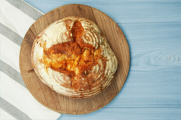 baked Italian bread on a light wooden table. ciabatta on a white towel on a wooden background	