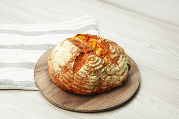 italian bread on a wooden stand on a light background. appetizing homemade bread on a wooden table	