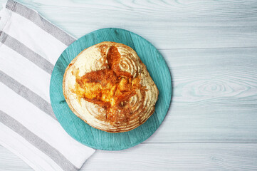 italian bread on a wooden stand on a light background. appetizing homemade bread on a wooden table	