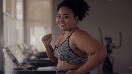 Fototapeta na wymiar plus size woman exercising in gym