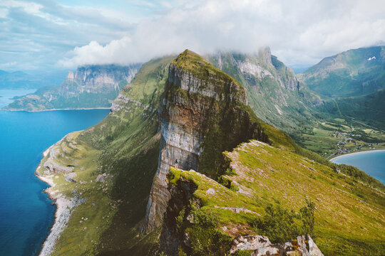 Man climbing mountains in Norway travel solo aerial view hiking outdoor adventure summer vacations healthy lifestyle trip freedom concept sustainable tourism
