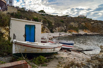 Fototapeta na wymiar Fishing boats in a natural and wild Mediterranean environment