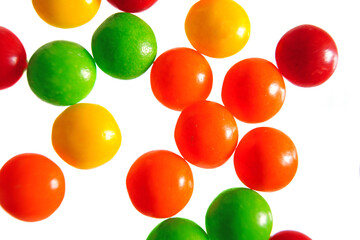 Colorful round candy pieces on white background