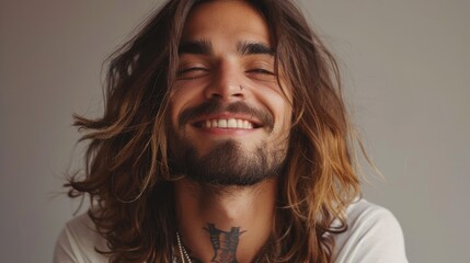 A close-up portrait of a young man with stylish long hair, queer man
