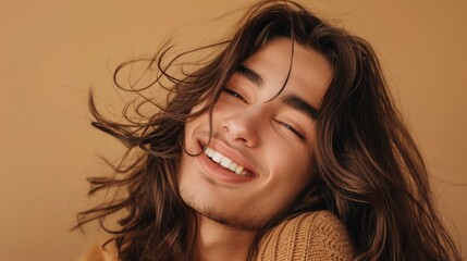 A close-up portrait of a young man with stylish long hair, queer man