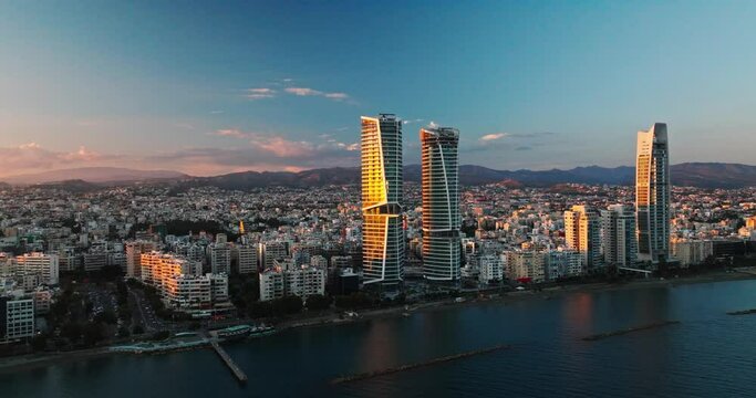 Majestic Sunset Over Limassol, Cyprus. Aerial Perspectives of Limassol's Modern Urban Landscape with High-Rise Glass Structures.