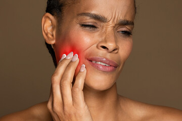 African american woman with red spot on cheek indicating pain