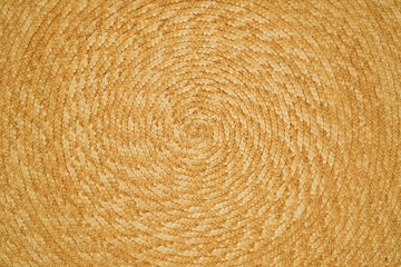 Braided straw textured surface making a spiral on wide background