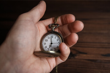 a pocket watch in the hands of a man
