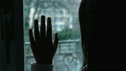 Moody Depiction of Child with Depression, Girl Leaning on Window Contemplating in Solitude