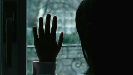 Moody Depiction of Child with Depression, Girl Leaning on Window Contemplating in Solitude