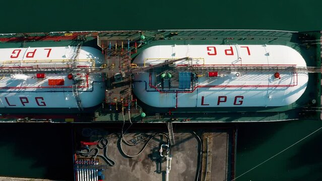 Aerial top down view ship LPG tanker vessel loading in gas and oil terminal station refinery, Global trading import export logistic transport sea freight Liquefied Petroleum Gas tanker