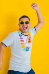 young Latino man celebrating and shouting that his team won and triumphed, while jumping up and...