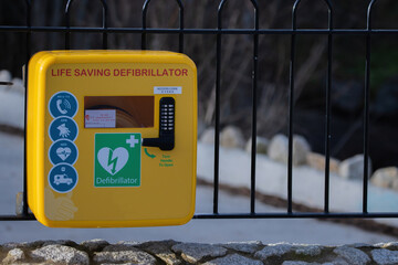 emergency defibrillator on a metal fence