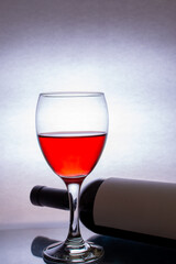 Glass of red wine with bottle