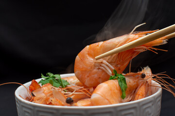 Hot juicy boiled shrimp on dark background