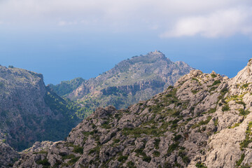 Fototapeta na wymiar Amazing landscapes of Mallorca. Majestic mountains covered with clouds, Sunny day. Mallorca, Spain, Balearic Islands