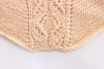 background of beige crochet ornament made of wool