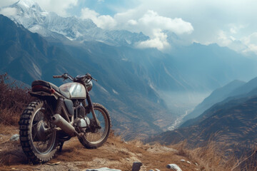 Motorcycle is parked on peak of mountain, showcasing the rugged terrain and adventurous spirit. Motorcycle trip