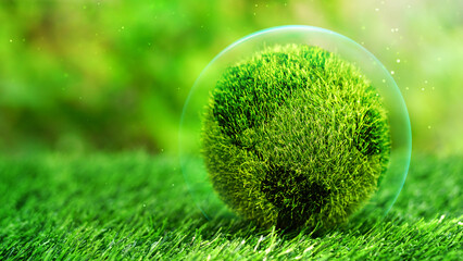 Green globe inside of bubble on grass field in natural background. Conservation concept, Safe...