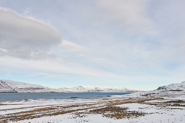 Northern landscapes: The calm waters of Hvalfjörður fjord lie beneath snow-capped mountains,...