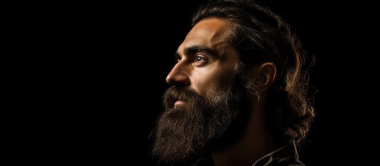 Mysterious Man Portraying Confidence with His Long Hair and Beard in a Dramatic Studio Setting